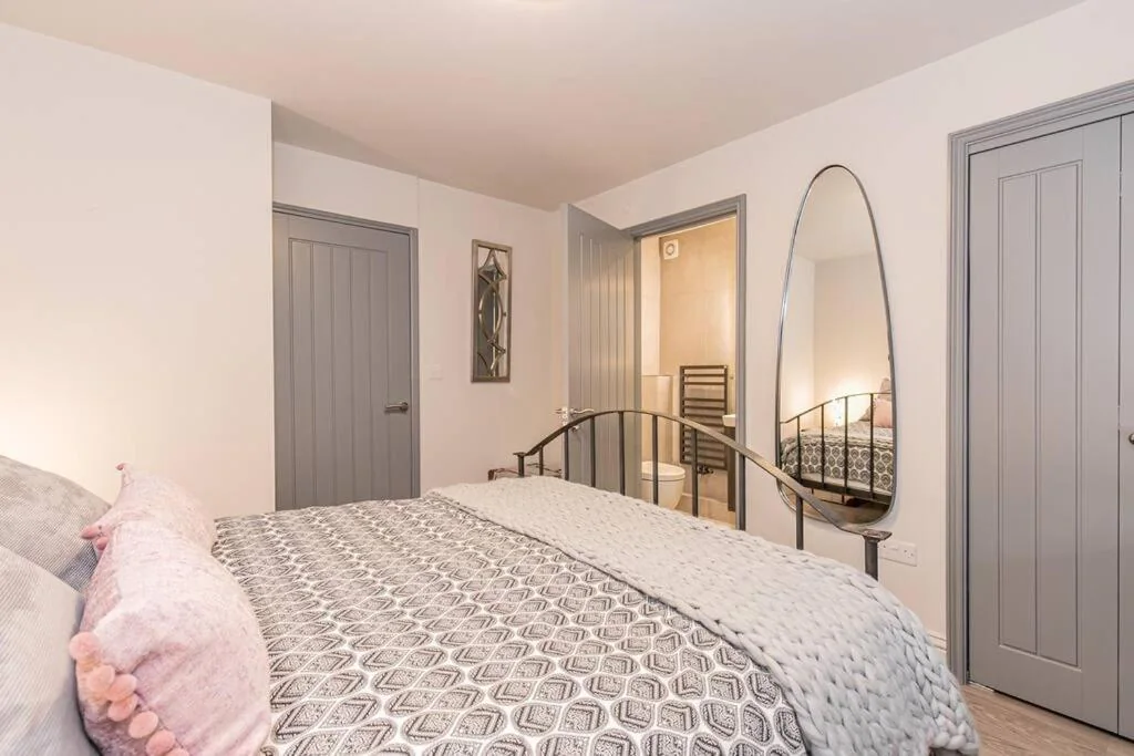 Main bedroom with dressing mirror and storage
