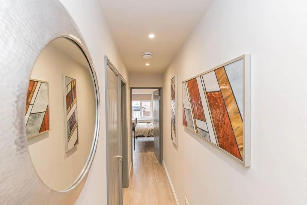 Hallway with artwork and mirror